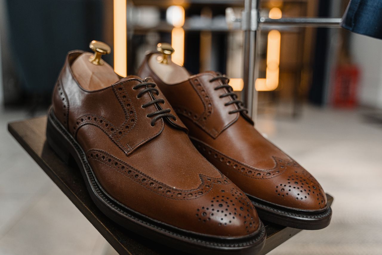 Crafting Captivating Headlines: Your awesome post title goes here Classic brown leather brogue shoes with detailed perforations on a stylish display.